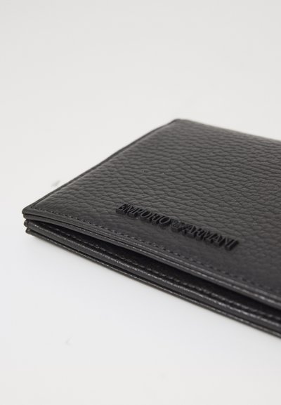 Black textured wallet with embossed logo, featuring a slim shape and smooth edges, showcasing a minimalist design.