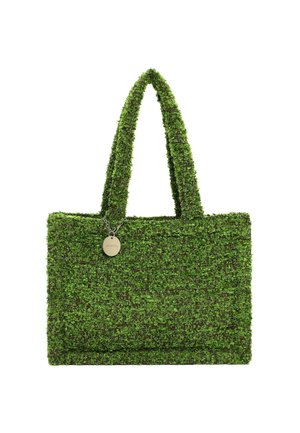 Green textured woven tote bag with two handles and a small round silver charm attached near the top center.