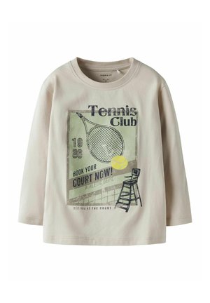 Light beige long-sleeve t-shirt featuring a tennis club graphic in green and black, depicting a racket, ball, and referee chair.