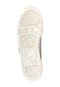 Suela de zapatilla blanca con un patrón de tracción hexagonal, acentos elevados y un detalle de logo circular. Goma texturizada para un buen agarre.