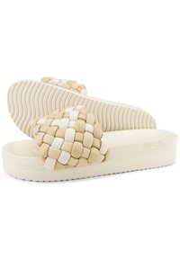 Woven slide sandals feature a cream and beige color scheme, a thick textured sole, and a cushioned upper with a braided design.