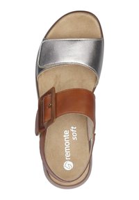 Brown and silver sandal with a smooth metallic upper, adjustable buckle, and comfortable tan insole. Brand name "remonte soft" visible.