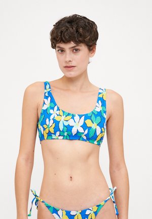 Floral bikini set featuring a blue base with yellow, white, and green flowers; textured fabric with a cropped top and tie-side bottoms.