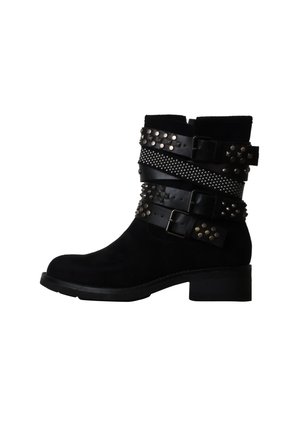 Bottine noire à petit talon, décorée de trois lanières en cuir cloutées et de boucles métalliques autour de la tige.
