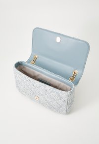 Blue tweed clutch bag with gold hardware; rectangular shape; soft texture; lined interior in light beige; snap closure on top.