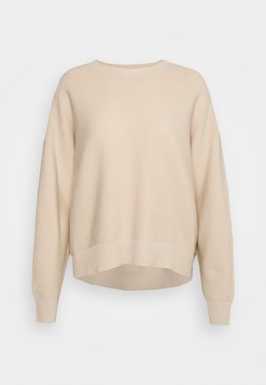 Beige gestrickter Pullover mit geripptem Saum und Bündchen, weiten Ärmeln und einer leicht verkürzten Silhouette. Weiche Textur und entspannte Passform.