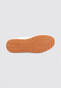 Baskets blanches avec une semelle en caoutchouc orange texturée présentant un motif en zigzag et une inscription en relief "JACK & JONES" sur le côté.