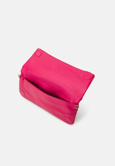 Rosa Leder-Clutch mit einer strukturierten Oberfläche, einem Reißverschluss oben und kreisförmigen Akzenten an beiden Seiten. Offenes Innenleben.