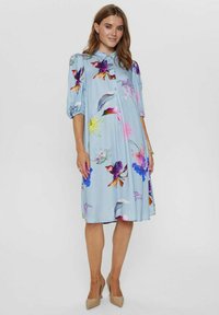 Lichtblauwe bloemenjurk met korte pofmouwen, knoopsluiting aan de voorkant en een rok tot op de knie. Bevat kleurrijke bloemen in verschillende maten.