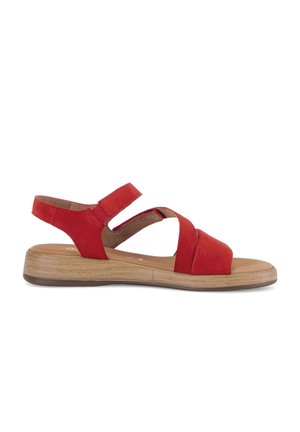 Red open-toe sandal with two straps over the foot and an adjustable ankle strap, featuring a low wooden-effect sole.