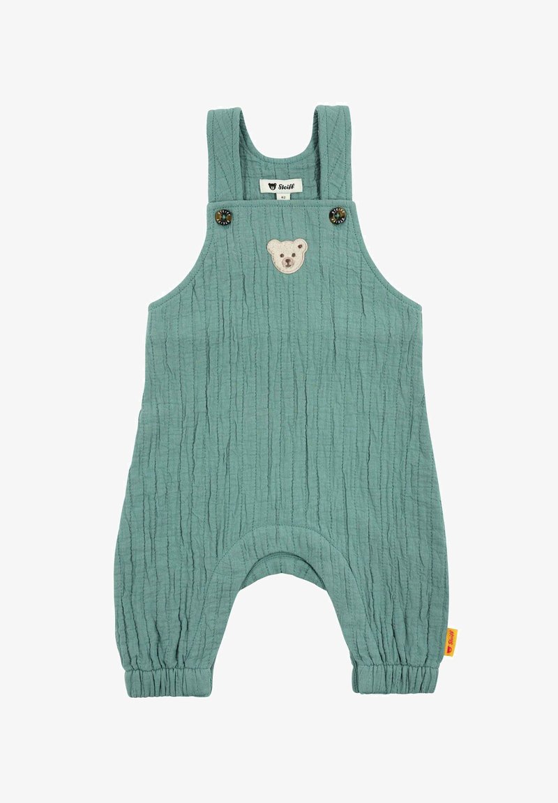 Grenouillère pour bébé verte texturée avec bretelles, fermetures à boutons, patch ours sur la poitrine et poignets élastiqués aux chevilles.