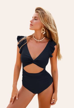 Costume da bagno intero nero con maniche a ruches, scollatura a V profonda, fronte attorcigliato e dettaglio a taglio. Tessuto liscio con texture arricciata lungo i fianchi.