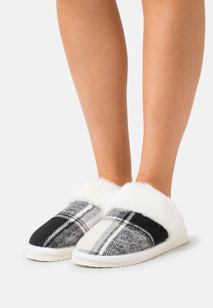 Gray and black plaid slippers with a soft white faux fur cuff, featuring a rounded toe and a flat, textured sole.