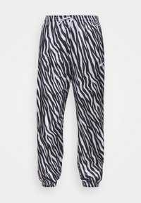 Kalhoty s potiskem zebry v černobílé barvě vyrobené z lehkého materiálu, s elastickým pasem na stahovací šňůrku a elastickými manžetami.