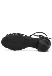 Black high-heeled sandal with suede sole, strappy design, and adjustable ankle strap. Features a textured sole for grip.