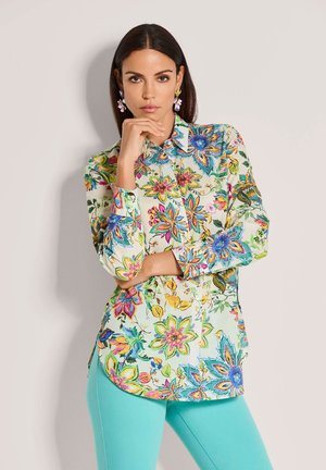 Blumiges Hemd zum Zumachen mit hellgrünem Hintergrund, verziert mit bunten Blumen und Blättern in Blau, Pink und Gelb. Lange Ärmel mit Manschetten.