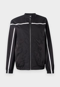 Black jacket with a high collar, zip closure, white side stripes, and flame embroidery on the front. Made from lightweight fabric.