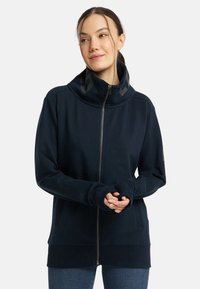 Marinefarbener Zip-Hoodie mit hohem Kragen, Daumenlöchern in den Ärmelbündchen und einem strukturierten Muster am Kragen. Weicher Stoff mit geripptem Saum.