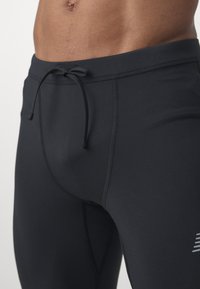 New Balance SLEEK REFLECIVE TIGHT - Leggings - black