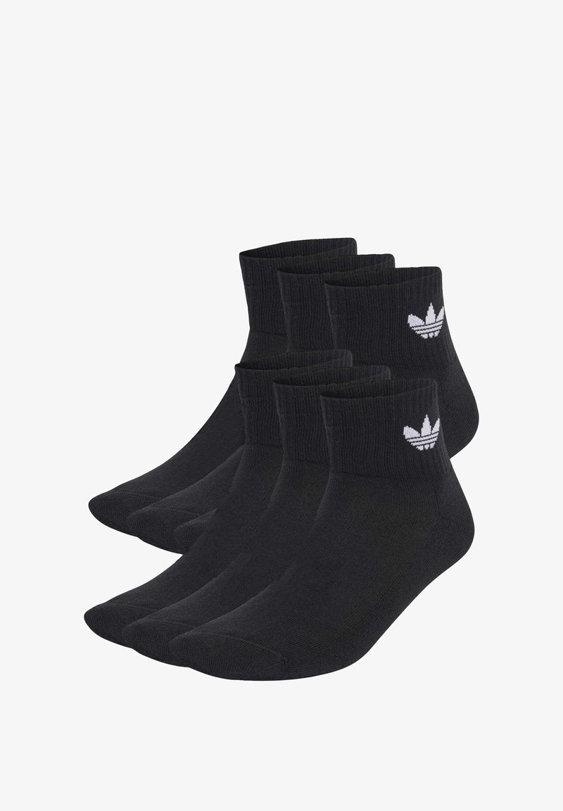 Melni biznesa zeķes, kas izgatavotas no kokvilnas maisījuma, ar ribotām malām un baltu trefoil logo uz katras zeķes. Komplektā ietilpst vairāki pāri.