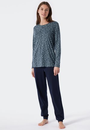 Langarmshirt in Türkis mit einem schwarzen abstrakten Muster, kombiniert mit dunkelblauen Jogginghosen, beide aus weichem, glattem Stoff.
