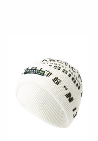 White knitted beanie featuring black text and patterns, with a logo patch in green and black. Flexible, ribbed texture with rounded top.