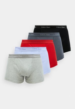 Five pairs of men's boxer trunks in gray, black, navy, red, and light blue. Elastic waistbands with "Calvin Klein" logo. Cotton blend fabric.