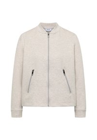 Veste beige clair à fermeture éclair avec deux poches zippées inclinées et un petit col montant, réalisée en tissu doux texturé.