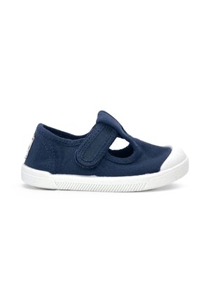 Chaussure pour tout-petit bleu marine avec embout en caoutchouc blanc, semelle blanche et bride Velcro ajustable sur le dessus.