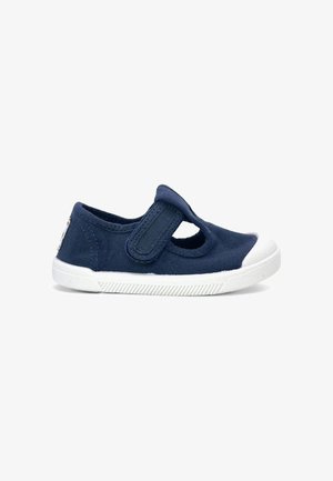 Chaussure pour tout-petit bleu marine avec embout en caoutchouc blanc, semelle blanche et bride Velcro ajustable sur le dessus.