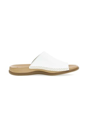 Witte open teen slide sandaal met een beige gevoerde voetbed en een flexibele, bruine zool, voorzien van decoratieve stiksels langs de bovenranden.