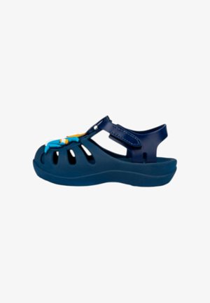 Sandalo blu navy per bambini con cinturino regolabile e decorazione a forma di pesce dei cartoni animati sulla parte anteriore, punta chiusa e lati aperti.