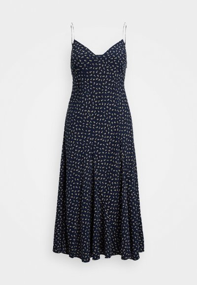 Mornarsko modra obleka s cvetličnim vzorcem, z V-izrezom, tankimi naramišnicami in zračno silhueto, ki sega do gležnjev. Mehak občutek tkanine.