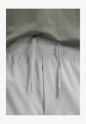 Graue Hose mit elastischem Bund und Kordelzug. Weicher Stoff, etwas lockere Passform und saubere Nahtdetails. Keine sichtbaren Muster oder Beschläge.