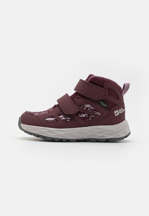 Maroon hiking shoes with two Velcro straps, mesh detailing, and a grey rubber sole. Features a cushioned collar and tongue for comfort.