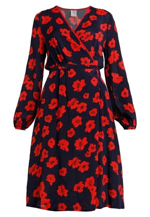 Mekko tummansinisestä kankaasta, jossa on rohkeita punaisia unikkokuvioita. Pitkät hihat, joissa on kerätty hihansuu, istuva vyötärö ja levenevä helma.