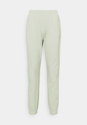Světle zelené teplákové kalhoty z měkké látky, s elastickým pasem a přiléhavými manžetami u kotníků. Jednoduchý design bez vzorů.