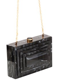 Sort akryl clutch taske med lagdelt rektangulært design, guld kædetraspe og rund lukning detalje. Glat tekstur med blank finish.