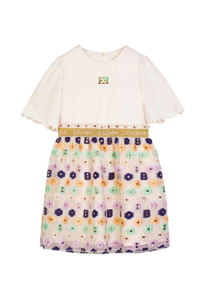 Top bianco con maniche corte a volant; gonna in tulle con motivo floreale viola e pastello; vita oro ESCADA; dettaglio del logo ricamato.