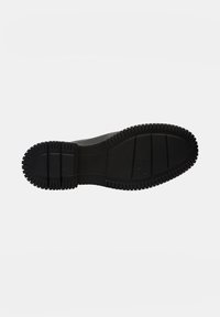 Black rubber shoe sole with a ridged texture, featuring horizontal grooves and raised edges for improved grip and durability.