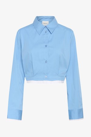 Cropped light blue button-up shirt with long sleeves, pointed collar, and white trim at the hem and cuffs.