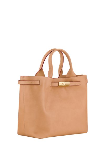 Tan leather tote bag with dual handles, a gold hardware clasp, and red interior lining. Smooth texture with minimalistic design and stitching.