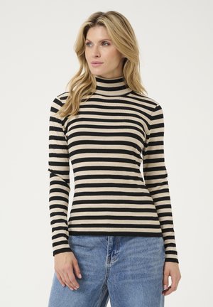 Black and beige striped turtleneck top in a fitted design, made of soft fabric, with long sleeves and a ribbed neckline. Paired with blue jeans.