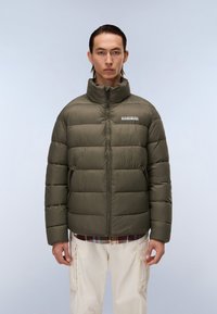Olive green puffer jacket with high collar, zip closure, and visible stitching. Features a logo at chest and side pockets for storage.