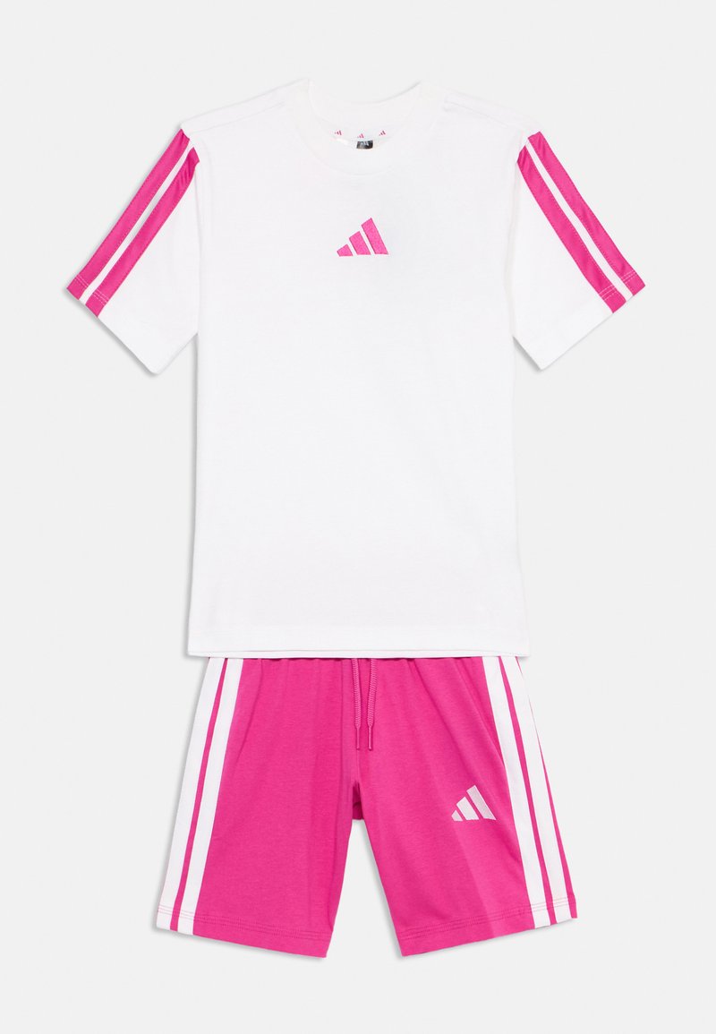 White athletic t-shirt with pink stripes on sleeves and a small pink logo. Pink shorts with white side stripes and matching logo. Cotton blend.