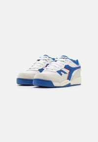 White and blue sneakers made of leather and suede with perforated details, a rubber sole, and red accent lines on the sides.
