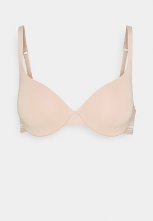 Reggiseno color beige chiaro con coppe lisce e sagomate, spalline regolabili e un dettaglio bandato testurizzato sui lati. Senza componenti visibili.