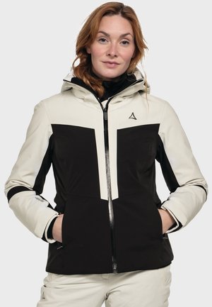 Lightweight, water-resistant jacket in cream and black, featuring a zippered front, adjustable hood, and two front pockets.