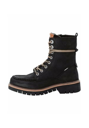 Black suede ankle boot with a rugged sole, contrasting stitching, and metallic laces. Features a padded collar and side branding detail.