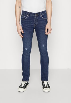 Dunkelblaue Skinny Jeans aus Denim mit leichter Distressierung an den Oberschenkeln, klassischem fünf Taschen Design und Reißverschluss.